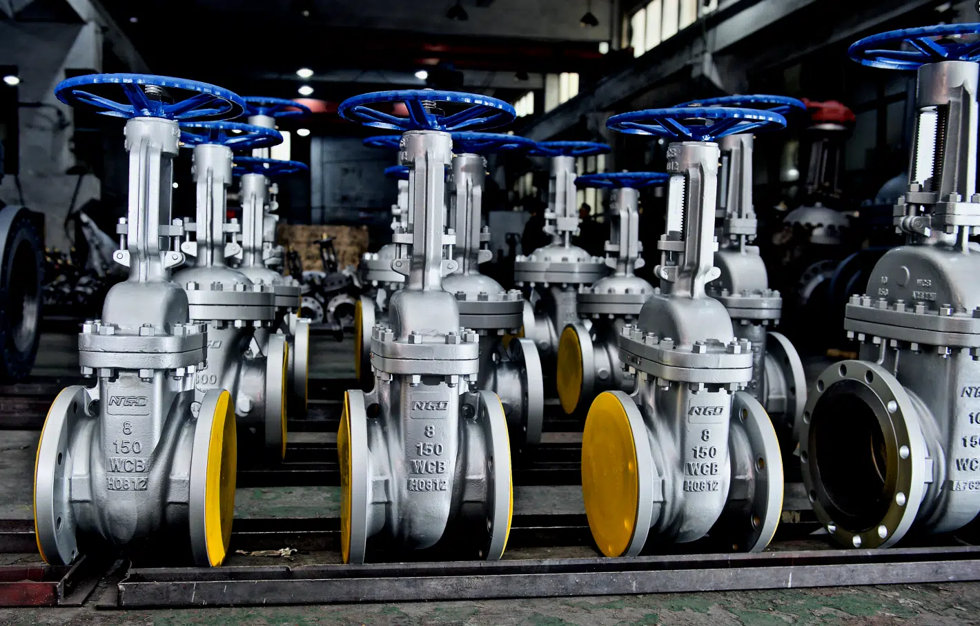 Industrial gate valve production line in factory showing large batch manufacturing and valve assembly