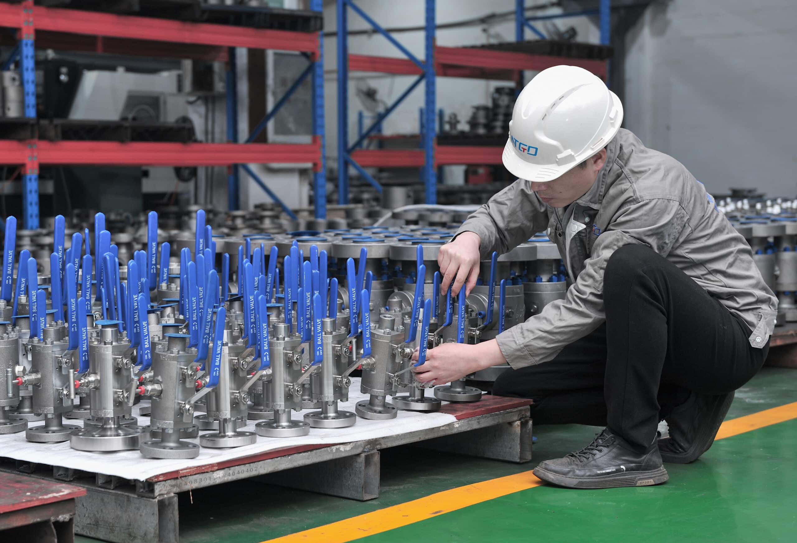 NTGD technician inspecting manual ball valves in workshop