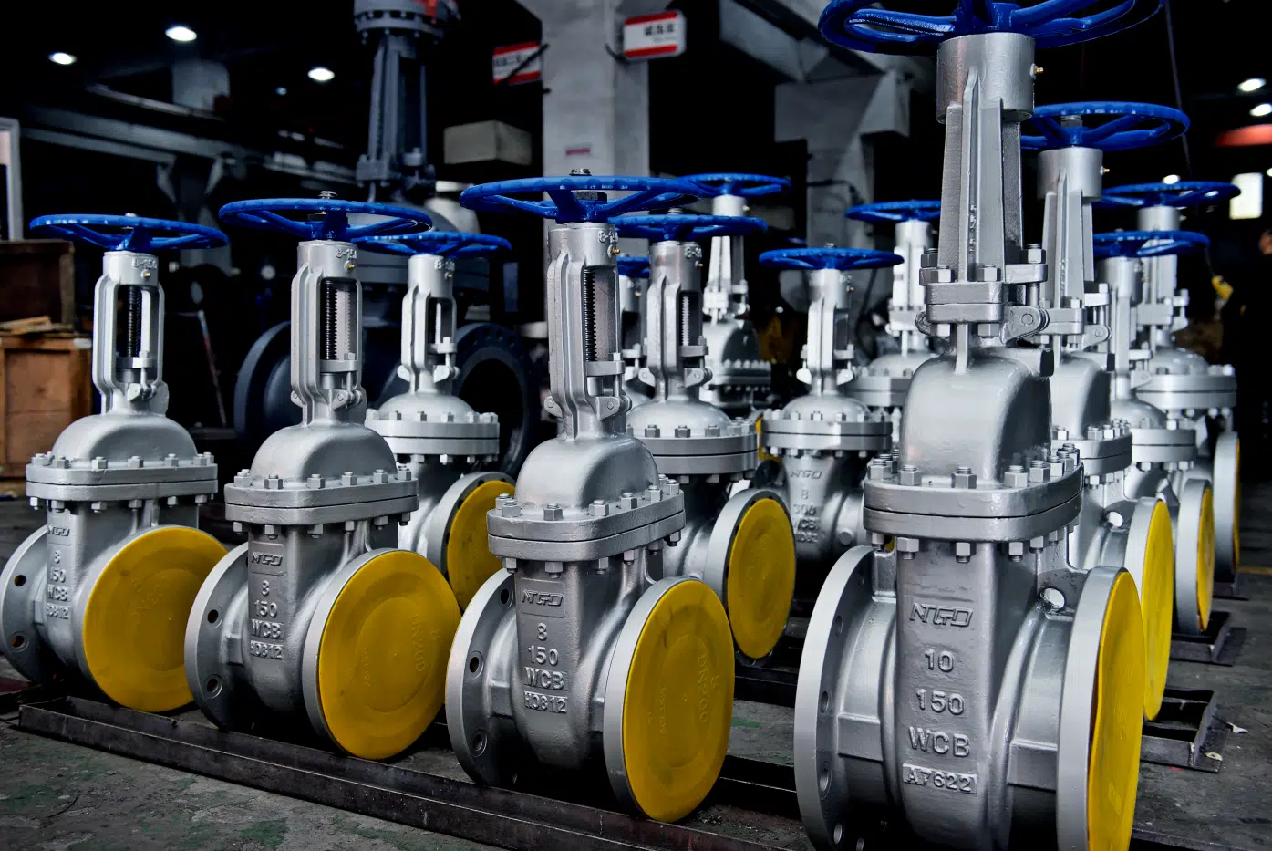 Class 150 WCB wedge gate valves lined up in an NTGD workshop.