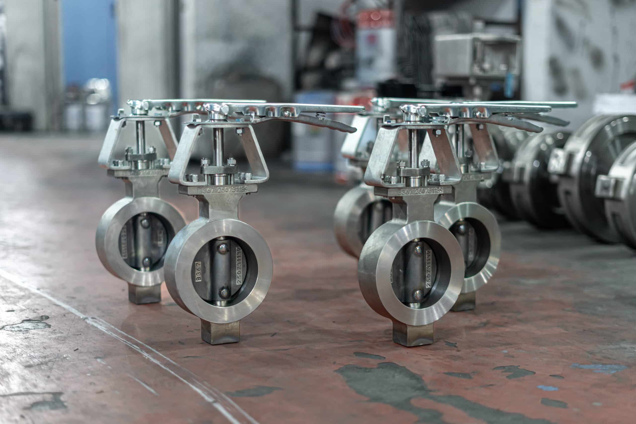 Stainless steel butterfly valves with lever operators in a workshop