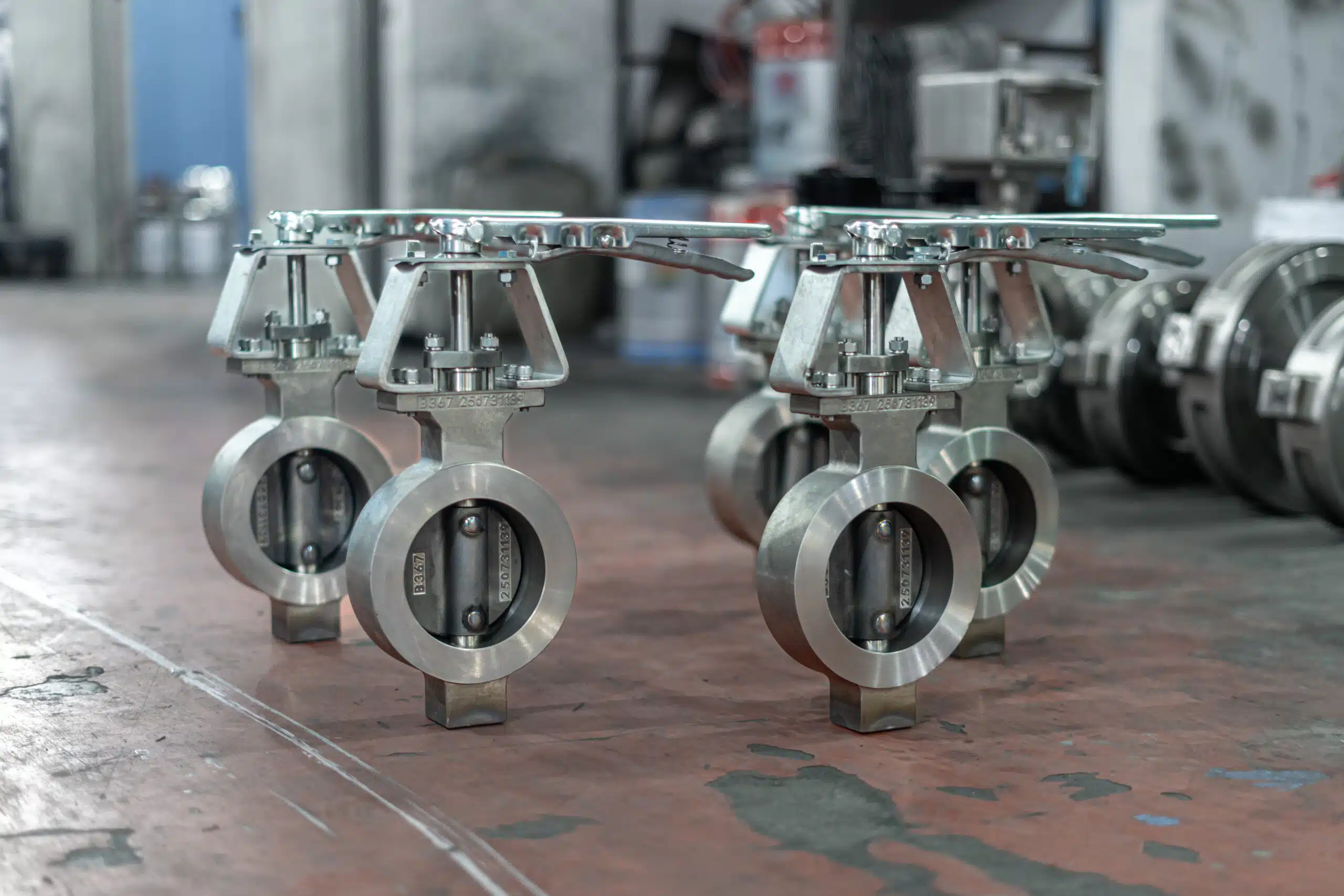 Stainless steel butterfly valves with lever operators in a workshop