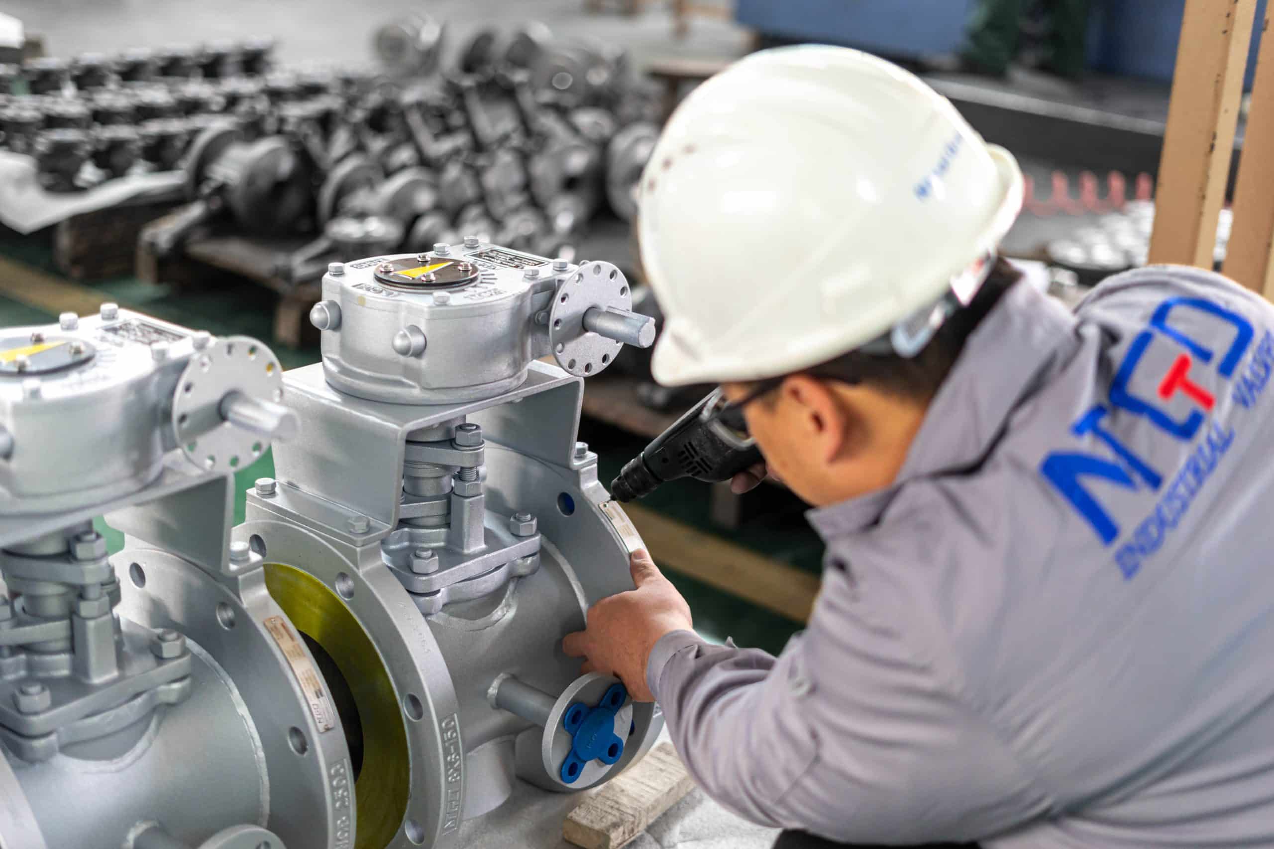 Plug valve assembly in industrial workshop showing manufacturing and quality control process