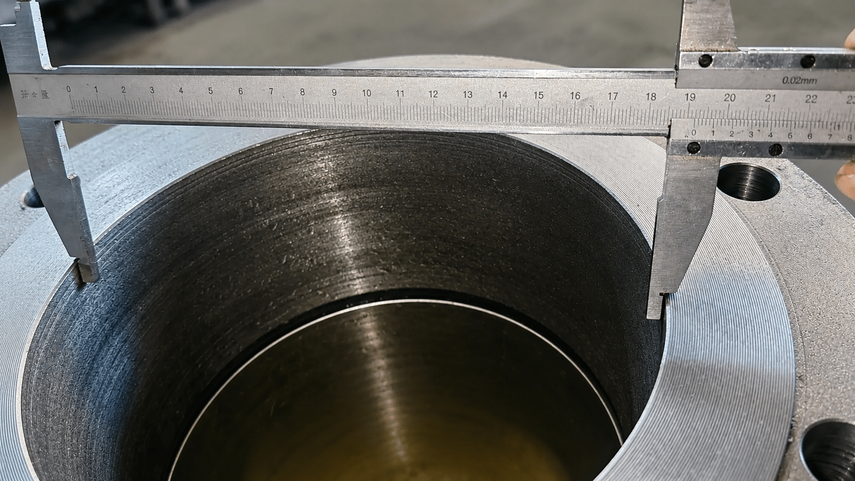 Caliper measurement of machined ball valve body bore during industrial inspection
