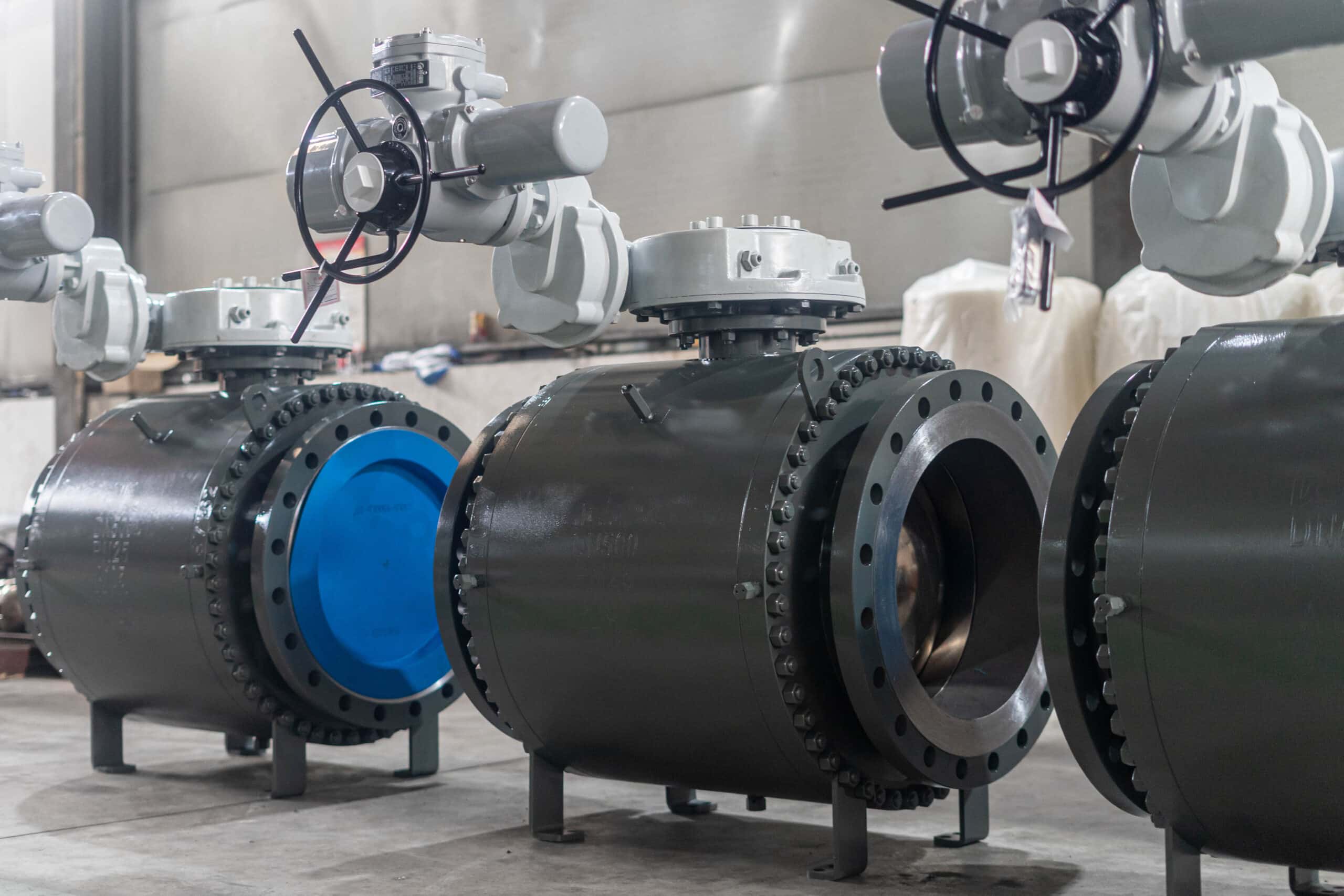 Large bore trunnion ball valves with gear operators in a workshop