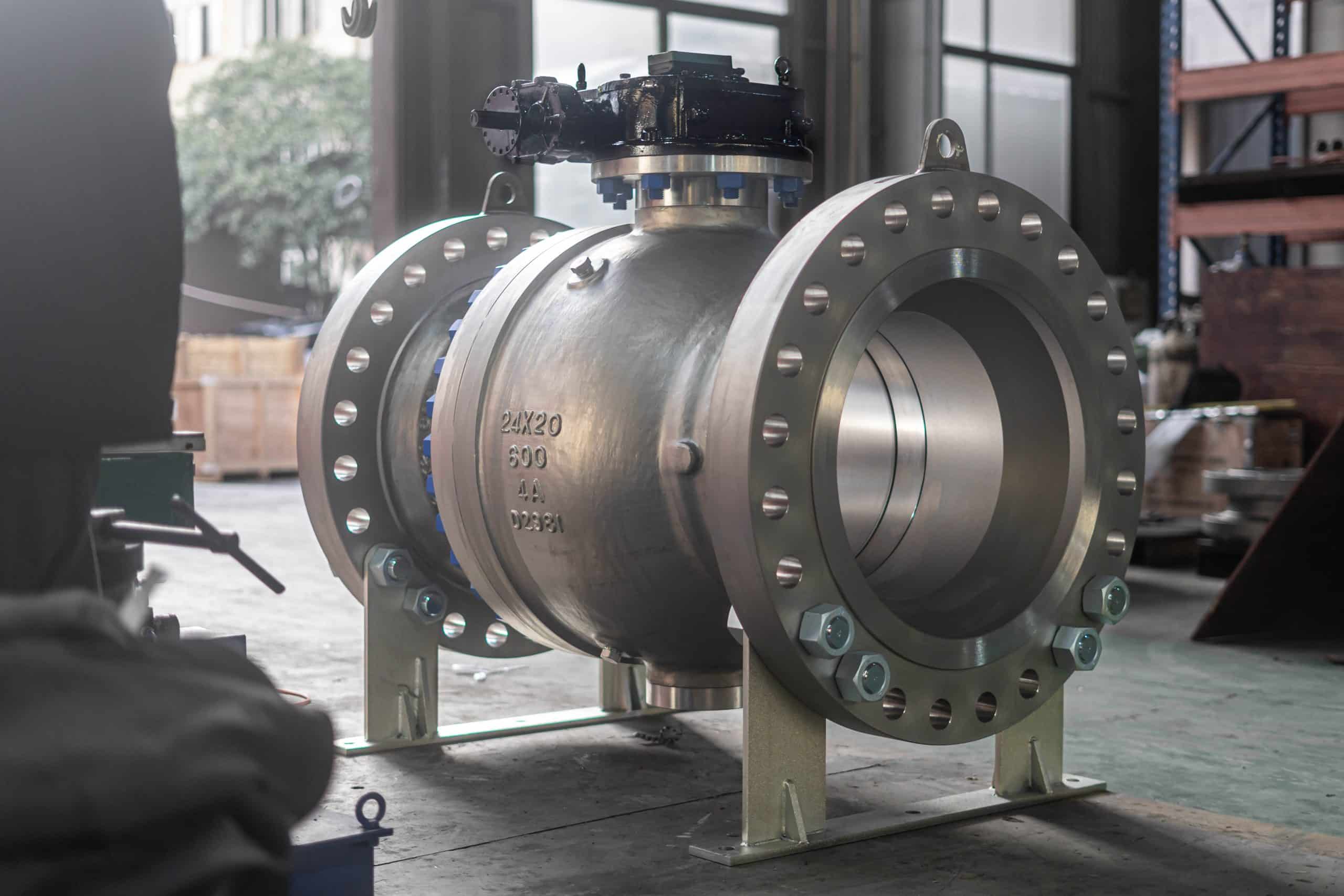 Large flanged ball valve with operator shown in a real factory setting
