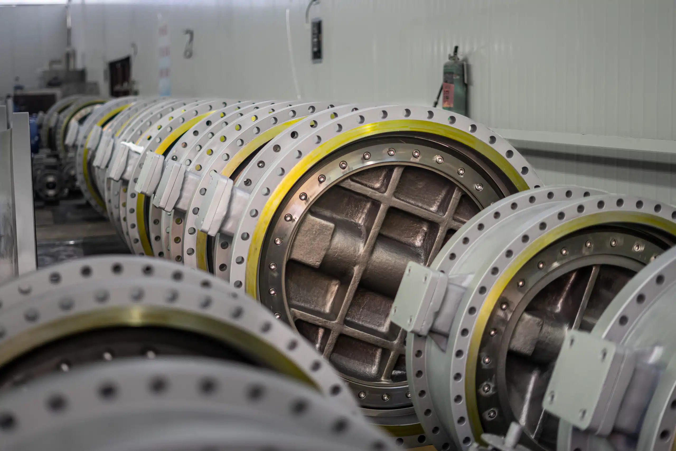 Large industrial butterfly valves lined up in a factory workshop showing real product manufacturing capability