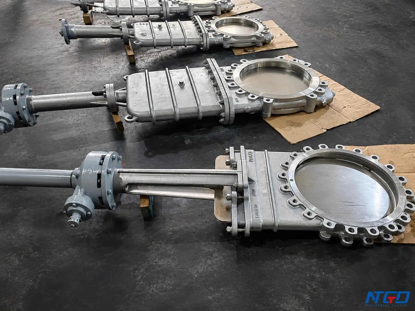 Large knife gate valves in NTGD workshop showing compact body and blade gate design