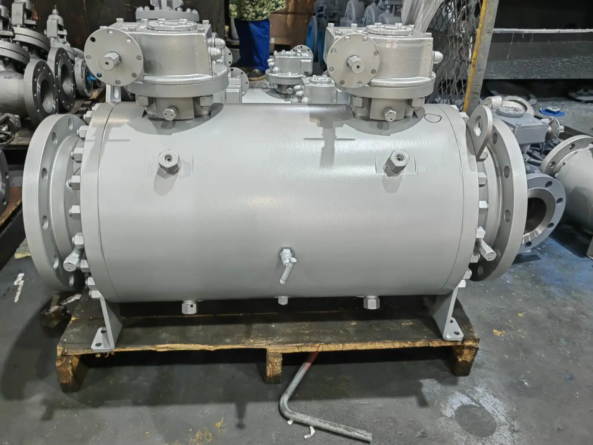 Large finished DBB valve assembly in workshop with flanged ends, bolted covers, fittings, and support legs