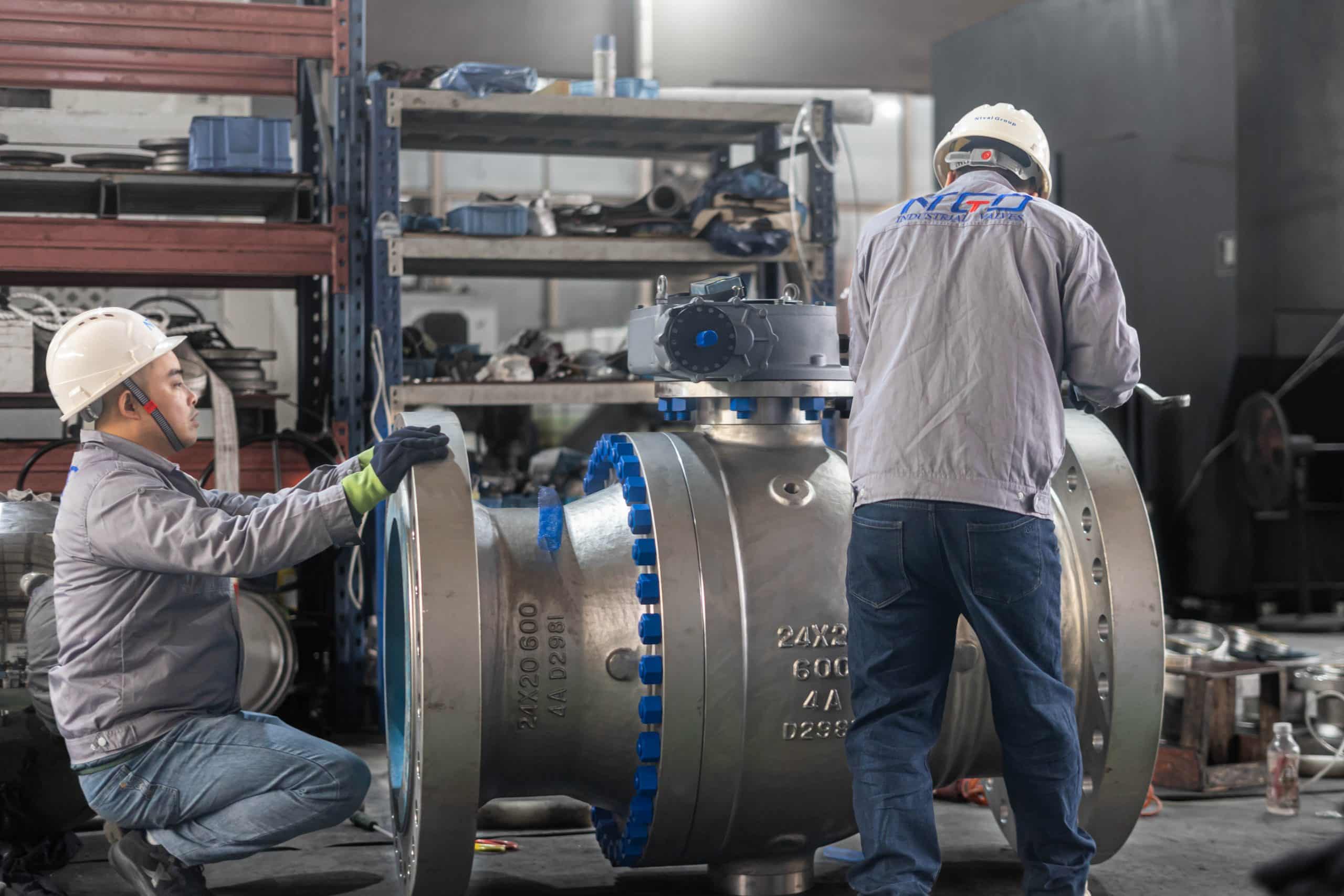 Large trunnion-mounted ball valve being inspected in a workshop for severe-service selection