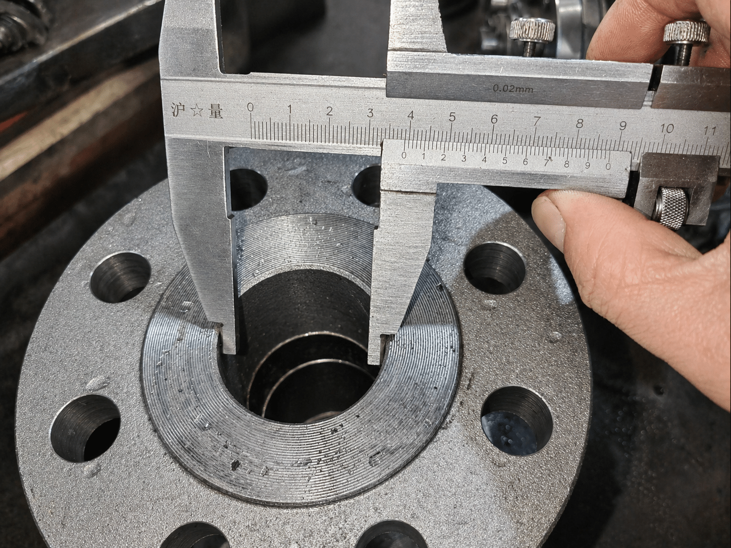 Caliper measuring a ball valve bore for full-port verification in slurry service