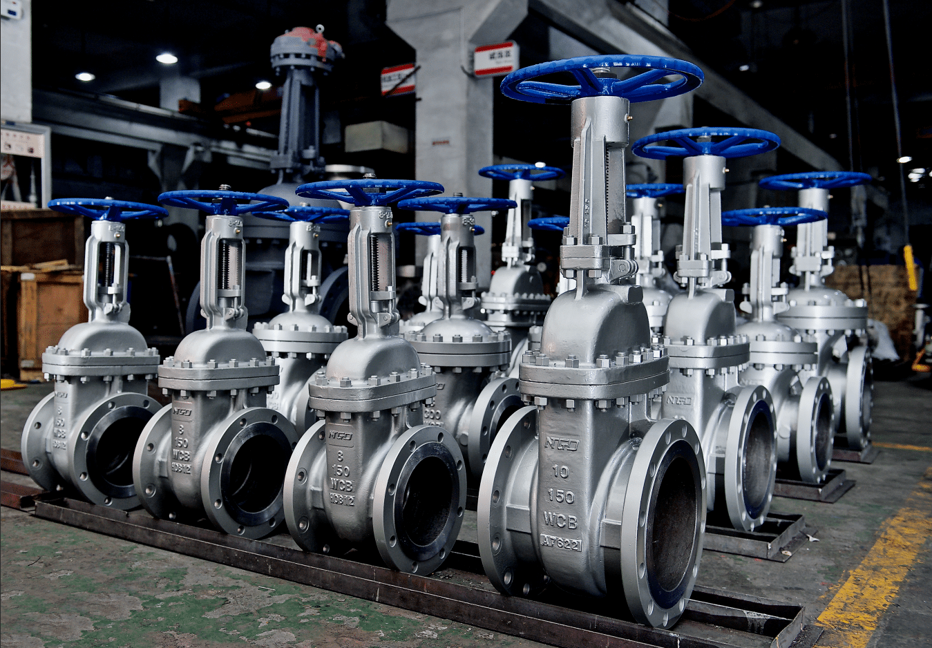 WCB flanged rising stem wedge gate valves lined up in workshop