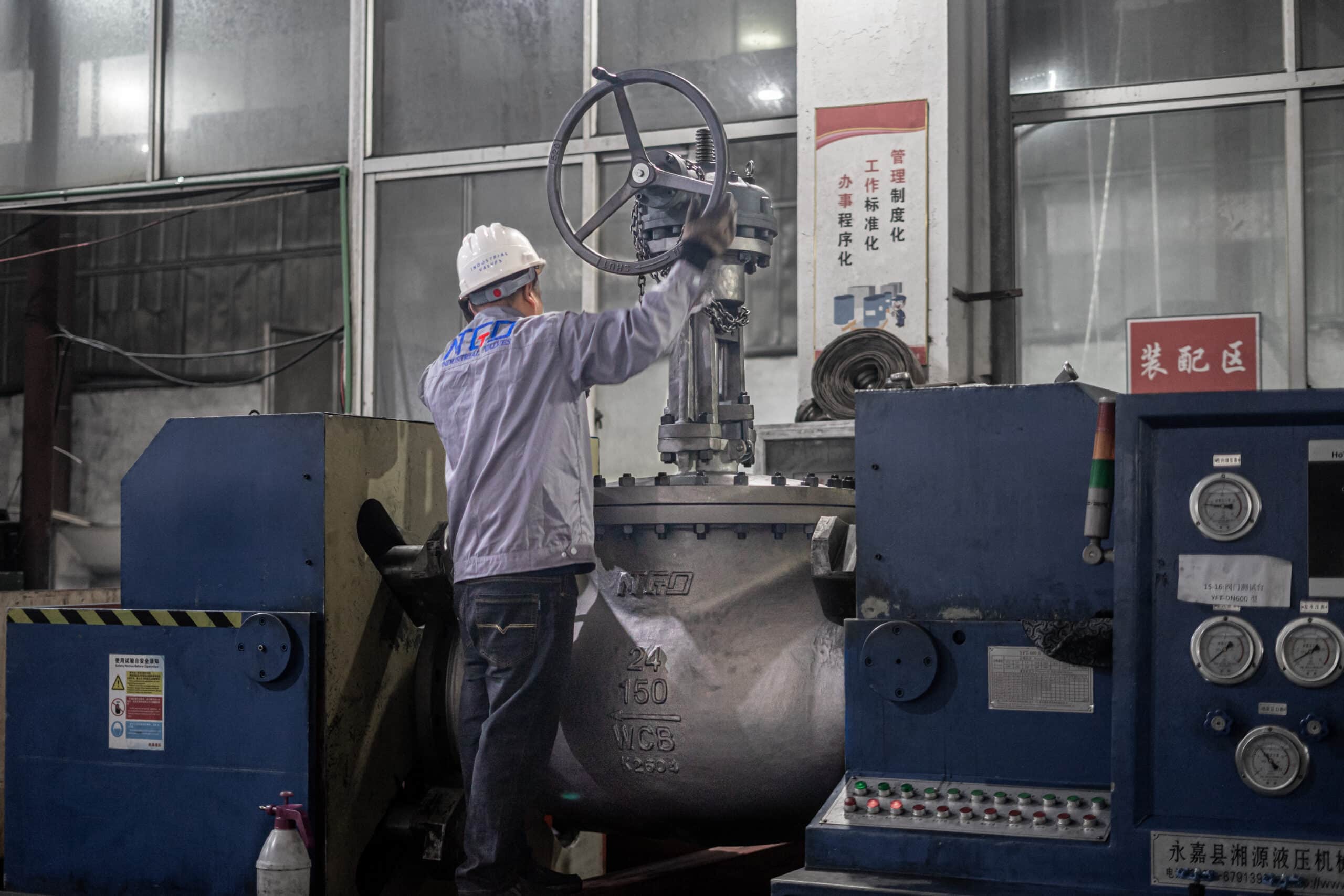 Real workshop photo of a large globe valve during pressure testing and inspection.