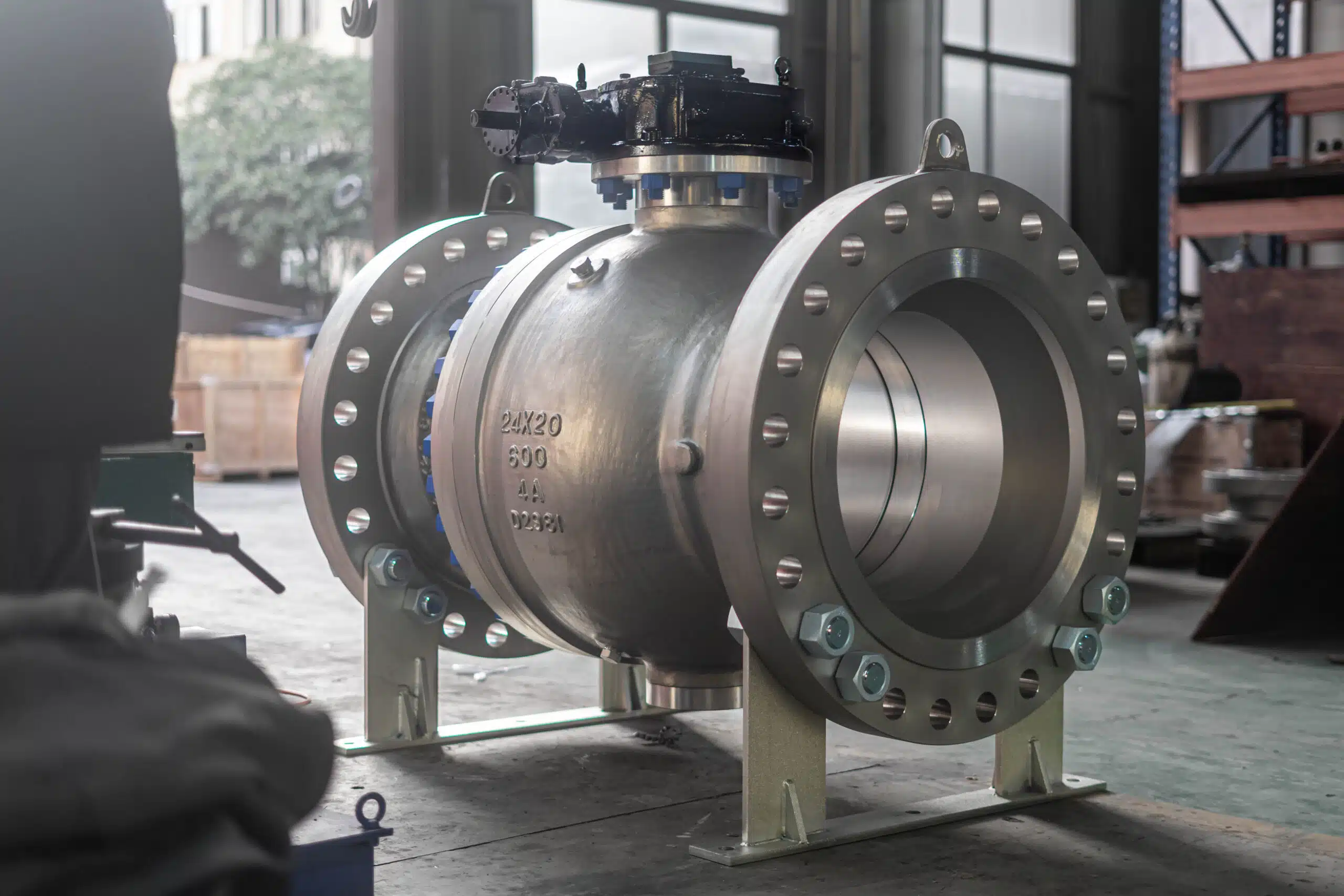 Large split-body trunnion ball valve with flanged ends in a workshop