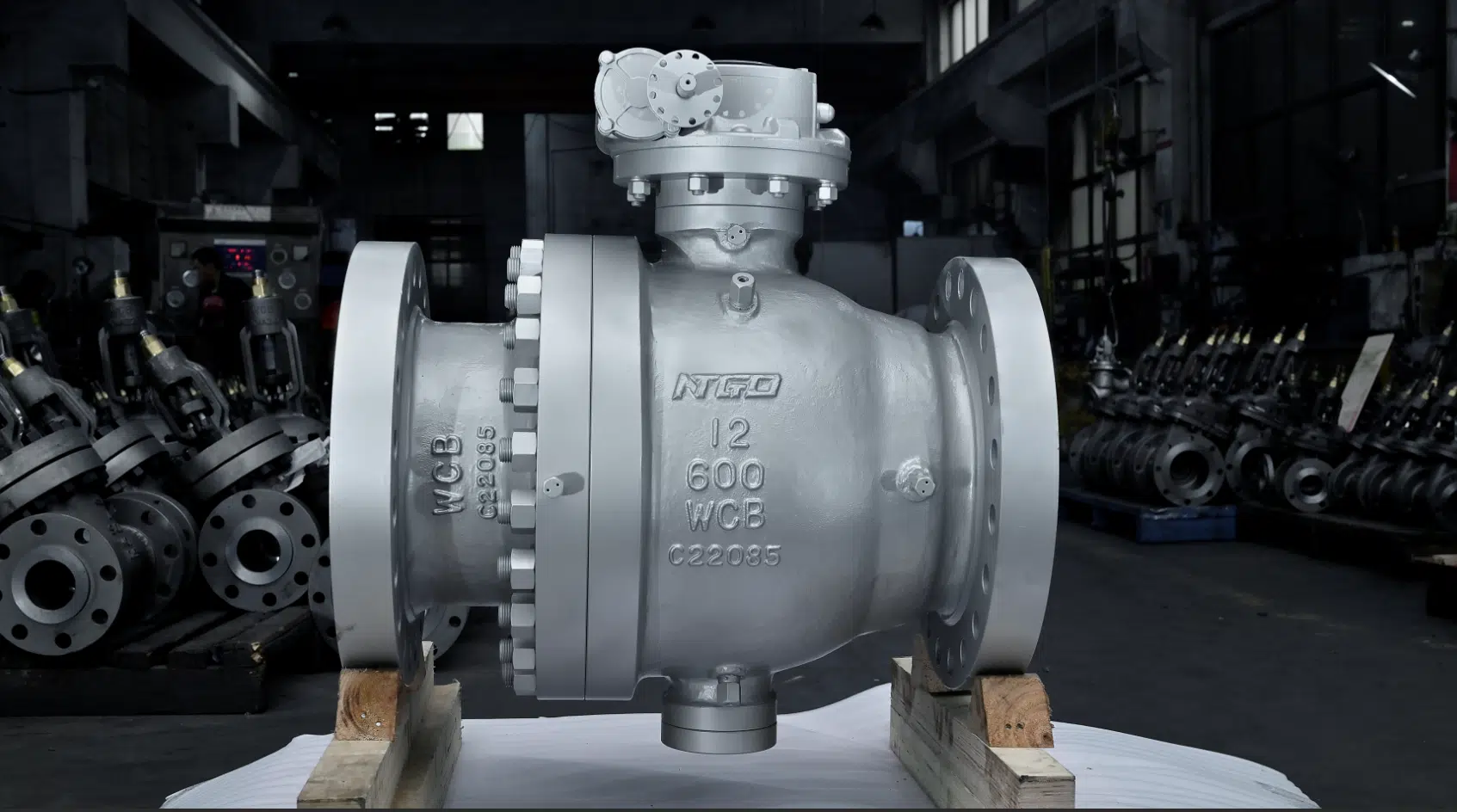A real NTGD workshop photo showing a technician measuring or checking flanged industrial ball valves. This image supports manufacturing credibility and helps connect the article’s working-principle explanation to real ball valve production and inspection.