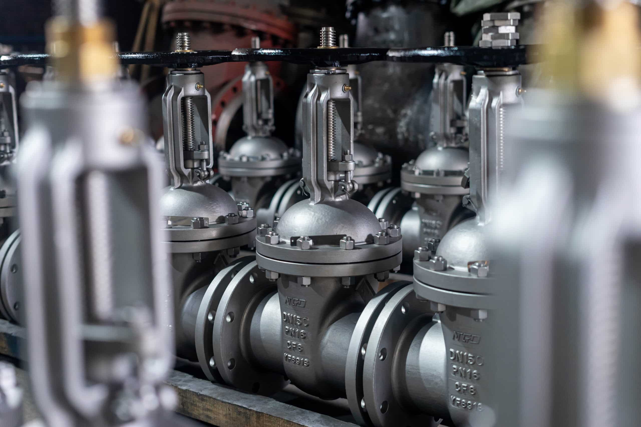 Real NTGD rising stem gate valves staged in workshop before inspection or shipment.